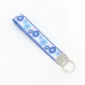 Detailed view of the blue floral embroidery and silver hardware of the wristlet - Blue and White Floral Pattern (04-04F)