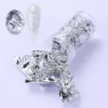 Professional silver nail art foil flakes in a transparent jar for manicure decoration - Silver