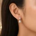 Nahaufnahme von Tropfenohrringen mit Blumenstecker am Ohr - Stil 8 / Silber