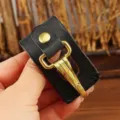 Close-up detail of black leather belt key holder with durable gold metal clasp and snap button. - Black