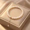 Exquisite natural pearl bracelet featuring a gold chain tassel pendant on a display box - Style 12