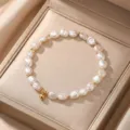 Detailed view of a natural baroque pearl bracelet with gold beads in a gift box. - Style 14