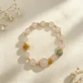 Natural rose quartz beaded bracelet with vintage gold charms and blue enamel bead. - Style 9