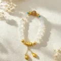 Handmade white natural crystal beaded bracelet with gold lotus charms and accents - Style 10