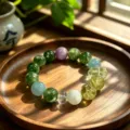Vibrant natural fluorite crystal beaded bracelet displayed on a rustic wooden tray in sunlight - Style 6