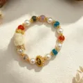 Handmade multi-color natural crystal beaded bracelet with a carved deity pendant - Style 14