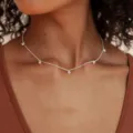 Nahaufnahme einer silbernen Halskette mit fünf kleinen, funkelnden Anhängern für Damen - Quaste Perle Stil / Stil 1 Silber