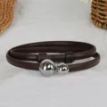 Detailed view of a slim brown leather belt featuring dual silver sphere metal clasps closeup. - Coffee With Silver Buckle