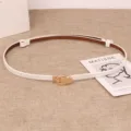 Women white thin leather belt with gold metal buckle, stylish minimalist waist accessory. - White