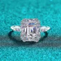 Elegant emerald-cut moissanite silver ring with a sparkling halo on a teal background - Size 9 / Emerald Cut Moissanite
