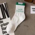 Men's white athletic mid-tube cotton socks with green cuffs and stylish letter knit design. - Men's One Size (Sizes 37-44) / White Base with Green Cuffs