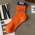 Orange cotton crew socks with blue ribbed cuff, casual sports socks featuring embroidered text. - Men's One Size (Sizes 37-44) / Orange Red