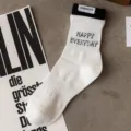 Men's white mid-tube cotton sports socks with black double layer rib cuff and letter knit design. - Men's One Size (Sizes 37-44) / White Base with Black Cuffs