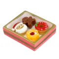 Close-up view of a miniature Christmas resin dessert tray featuring Santa and a gingerbread man. - Pink and Gold Border Christmas Set