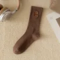 Brown ribbed mid-calf socks for women featuring a stylish embroidered letter C design. - Dark Coffee