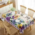 Detail view of spring floral waterproof rectangular tablecloth setting on wooden dining table. - Style 8