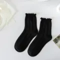 Chaussettes mi-hautes noires en tricot avec volants pour femmes, style chic et beau. - Taille unique / Noir - tricot torsadé à bord roulé