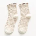 Vintage beige jacquard mid-calf socks for women with stylish brown ruffle trim and toe. - One Size / Off White