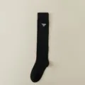 Black knee high socks featuring white bee embroidery, ribbed design, classic fashion style. - One Size / Black