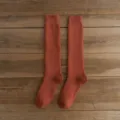 Solid rust red winter warm long calf socks variant display, soft knitted thermal hosiery. - One Size / Orange