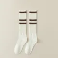 Classic white knee-high socks for women, featuring chic brown stripes and cozy ribbed knit texture. - One Size / White with Coffee Stripes