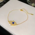Elegante bracciale mano di Fatima in acciaio al titanio dorato con malocchio blu e zirconi - Stile Occhio Blu Scuro 2 (Stile 2)