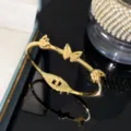 Elegant gold-plated titanium steel butterfly charm bangle for women with hinge clasp detail - Gold - Three Butterflies Bangle