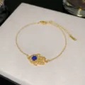 Bracelet élégant en acier titane doré avec main de Hamsa et motif œil bleu porte-bonheur. - Style Œil Bleu Pave 10 (Style 10)