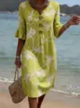 Detailed view of women's lime green V-neck embroidered linen dress with buttons at beach. - Yellow Coconut Print
