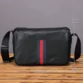 Detailed view of the men's genuine leather messenger bag with dimensions and stylish striped design. - Black