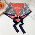 Sciarpa triangolare stampata con fibbia magnetica di perla, dettaglio elegante da donna. - Fibbia di Perla - Fiore Arancione a Cinque Petali