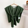 Detailed view of the dark green knitted shawl, showing fine texture and front knot design. - Army Green