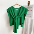 Green knitted shawl top detail view, elegant front tie wrap design, lightweight summer layer. - Green