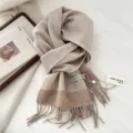Detail view of the cozy lamb wool winter tassel scarf featuring a classic herringbone pattern. - 31*183cm / 07 Lambswool Coffee