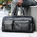 Bolsa de viaje de cuero genuino negro para hombre, elegante bolso de mano con bolsillos. - Negro