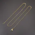 Gold tone cable chain necklace detail showing durable lobster clasp and smooth metal links. - O Chain