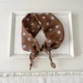 Detailed view of women's brown cotton linen square scarf with blue dot patterns for spring. - Line Ball Brown