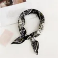 Geometric print silk scarf detail, elegant black and gold pattern accessory for women daily wear. - Compass