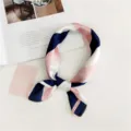 Detailed close-up of the elegant silk-feel square scarf featuring pink and navy striped pattern. - Striped Pink