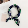 Detailed view of women's small silk square scarf, navy blue with chic green white geometric print. - Green-Haired Witch