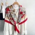 Detailed close-up view of vintage floral print square scarf elegantly draped on white blouse. - Bright Red