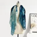 Detail view of the blue tie-dye silk cotton scarf, showcasing artistic gradient texture. - Vast Blue Wave