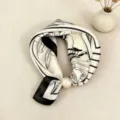 Close-up detail of the elegant black and white silk scarf with pearl magnetic clasp. - CXK006-White Chinese Rose