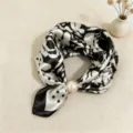 Detail view of a chic black and white silk scarf with pearl magnetic clasp, elegant and stylish. - CXK006-Ink Wash Plum Blossom