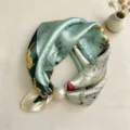 Close-up detail of silk neckerchief with animal print and magnetic pearl buckle. - CXK006-Hand-Drawn Rabbit