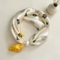 Elegant imitation silk scarf detail view featuring floral print and pearl magnetic buckle. - CXK006-Yellow-Edged Rose