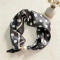 Detailed view of silk scarf with polka dots and pearl magnetic buckle for professional wear. - CXK005-Black Polka Dots