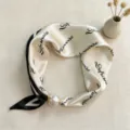 Elegant black and white silk scarf with letter print and pearl magnetic clasp accessory detail. - CXK005-Black and White Letters