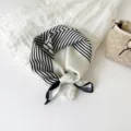 Elegant black and white striped silk scarf detail, chic geometric neckerchief design. - White