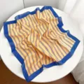 Striped cotton square scarf detail showcasing fabric texture and vibrant blue border design. - Yellow Stripe